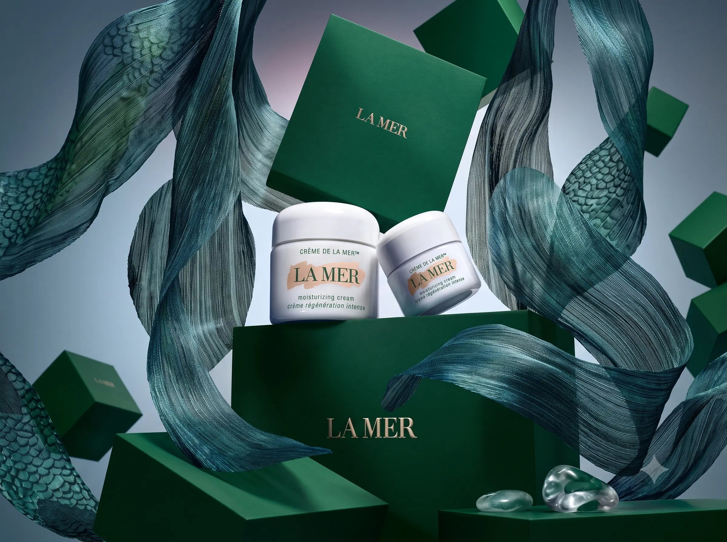 Hands warming Crème de la Mer between the fingertips until the balm turns translucent